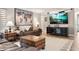 Inviting living room featuring a comfortable leather sofa, stylish decor, and a large flat-screen TV at 155 Donna Ct, Punta Gorda, FL 33950