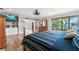 Bright main bedroom with TV and view of the water, complemented by hardwood flooring at 155 Donna Ct, Punta Gorda, FL 33950