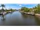 Scenic waterfront view featuring docks, boats, and lush greenery against a blue sky with scattered clouds at 155 Donna Ct, Punta Gorda, FL 33950