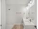 Stylish bathroom featuring a double vanity, sleek fixtures, and walk-in shower with white marble tile at 16218 Chamberlain Blvd, Port Charlotte, FL 33954