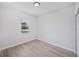 Bright bedroom featuring neutral walls, wood-look flooring, and a window with neighborhood views at 16218 Chamberlain Blvd, Port Charlotte, FL 33954