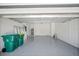 Spacious garage with epoxy floors, white walls, rear doors, and ample storage space at 16218 Chamberlain Blvd, Port Charlotte, FL 33954