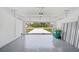 Clean garage with epoxy flooring, white block walls, overhead door and neighborhood views at 16218 Chamberlain Blvd, Port Charlotte, FL 33954