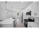 Well-lit kitchen with stainless steel appliances, quartz countertops, and an open layout at 16218 Chamberlain Blvd, Port Charlotte, FL 33954