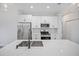Modern kitchen with stainless steel appliances, white cabinets, and a sleek quartz countertop at 16218 Chamberlain Blvd, Port Charlotte, FL 33954