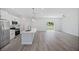 Open-concept kitchen and living area with modern appliances and ample space for entertaining at 16218 Chamberlain Blvd, Port Charlotte, FL 33954