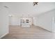 Bright, open-concept living space featuring modern flooring and an adjacent kitchen with island at 16218 Chamberlain Blvd, Port Charlotte, FL 33954