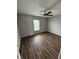 Bedroom features wood flooring, a ceiling fan, and a window at 16280 Minorca Dr, Punta Gorda, FL 33955