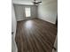 Spacious bedroom with wood flooring, a ceiling fan, and a large window providing natural light at 16280 Minorca Dr, Punta Gorda, FL 33955