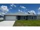 Charming single-story home features a gray exterior, well-maintained lawn, and an attached two-car garage at 16280 Minorca Dr, Punta Gorda, FL 33955