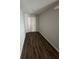 Hallway with wood floors leading to a door at 16280 Minorca Dr, Punta Gorda, FL 33955