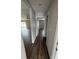 Hallway leads to rooms with light gray walls and wood floor at 16280 Minorca Dr, Punta Gorda, FL 33955