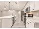 Bright kitchen with stainless steel appliances, white cabinets, quartz countertops and a kitchen island at 16280 Minorca Dr, Punta Gorda, FL 33955
