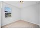 Bright bedroom has wood-look floors and a window with views of the yard at 17197 Russell Ave, Port Charlotte, FL 33954