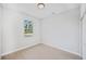 Bright, minimalist bedroom features natural light and wood look floors at 17197 Russell Ave, Port Charlotte, FL 33954