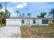 Charming single-story home featuring a gray brick driveway and a freshly painted white exterior at 17197 Russell Ave, Port Charlotte, FL 33954