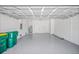 Spacious two car garage with painted walls and ceiling, showing doors to the interior and exterior at 17197 Russell Ave, Port Charlotte, FL 33954