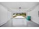 Two car garage with gray epoxy flooring, and view of the exterior paved driveway at 17197 Russell Ave, Port Charlotte, FL 33954