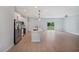Open-concept kitchen with stainless steel appliances, center island, and sliding doors leading to the backyard at 17197 Russell Ave, Port Charlotte, FL 33954