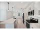 Open kitchen boasts quartz counters, stainless appliances, and a large island at 17197 Russell Ave, Port Charlotte, FL 33954