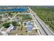 Aerial view of the home showcasing the lot, location near a highway and pond, and nearby neighborhood at 19468 Edgewater Dr, Port Charlotte, FL 33948