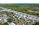 Aerial view of property showing its location near a highway, with lush greenery, pond, and a partial water view at 19468 Edgewater Dr, Port Charlotte, FL 33948