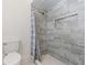 Updated bathroom with a shower featuring stylish gray tiling and built-in shelving at 19468 Edgewater Dr, Port Charlotte, FL 33948