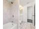 This bathroom has a shower and tub combination with stylish gray tile and new fixtures at 19468 Edgewater Dr, Port Charlotte, FL 33948