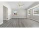 Spacious primary bedroom featuring laminate flooring, ceiling fan, and natural lighting at 19468 Edgewater Dr, Port Charlotte, FL 33948