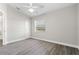 Bright bedroom with new floors, a ceiling fan, and a large window for natural light at 19468 Edgewater Dr, Port Charlotte, FL 33948