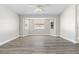 Bright and open bedroom featuring laminate flooring, ceiling fan and three windows at 19468 Edgewater Dr, Port Charlotte, FL 33948