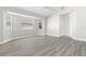 Bright and open bedroom featuring laminate flooring, ceiling fan and three windows at 19468 Edgewater Dr, Port Charlotte, FL 33948