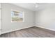 Light-filled bedroom with a ceiling fan, new floors, and large windows with a view at 19468 Edgewater Dr, Port Charlotte, FL 33948