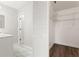Walk-in closet with white wire shelving and laminate flooring located next to the bathroom at 19468 Edgewater Dr, Port Charlotte, FL 33948