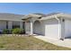 Exterior view of the home showcasing a well-maintained lawn and charming front entrance at 19468 Edgewater Dr, Port Charlotte, FL 33948