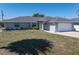 Charming one-story home with a well-manicured lawn and a two-car garage at 19468 Edgewater Dr, Port Charlotte, FL 33948