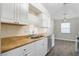 Bright kitchen featuring white cabinets, light-colored countertops, and stainless steel appliances at 19468 Edgewater Dr, Port Charlotte, FL 33948