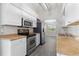 Updated kitchen with stainless steel appliances, white cabinets, and tile flooring at 19468 Edgewater Dr, Port Charlotte, FL 33948