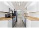 Modern kitchen with white cabinetry, stainless steel appliances, light countertops, and stylish tile flooring at 19468 Edgewater Dr, Port Charlotte, FL 33948