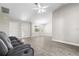 Open-concept living room featuring tile flooring, a ceiling fan, and natural lighting at 19468 Edgewater Dr, Port Charlotte, FL 33948