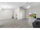 Open-concept living area with gray wood-look tile, vaulted ceilings, and a sliding glass door to the backyard at 19468 Edgewater Dr, Port Charlotte, FL 33948