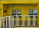 Front balcony with white railing and windows for a sunny, bright space in yellow condo at 2060 Willow Hammock Cir # 301, Punta Gorda, FL 33983