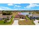 Aerial view of a home on a large lot with lake view featuring a large pool, screened-in lanai and attached garage at 2152 Taiwan Ct, Punta Gorda, FL 33983
