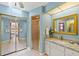 Bright bathroom featuring granite counters, mirrored closets, and walk-in shower at 2152 Taiwan Ct, Punta Gorda, FL 33983