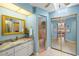 Bright bathroom features a marble countertop vanity, walk-in shower and large mirror sliding door to the bedroom at 2152 Taiwan Ct, Punta Gorda, FL 33983