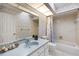 The bathroom features a vanity, tub, shower, toilet and floral wallpaper with a decorative sky light at 2152 Taiwan Ct, Punta Gorda, FL 33983