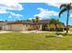 Charming single-story home with palm trees, neutral exterior, and a well-maintained lawn at 2152 Taiwan Ct, Punta Gorda, FL 33983