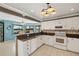 Kitchen features white cabinets, dark countertops, and an open view to the lanai at 2152 Taiwan Ct, Punta Gorda, FL 33983