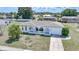 An elevated view of a single story home with white exterior, neutral roof, and a paved driveway at 2166 Beacon Dr, Port Charlotte, FL 33952