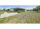 Spacious backyard with mature trees and minimal landscaping offers peaceful outdoor living at 2166 Beacon Dr, Port Charlotte, FL 33952
